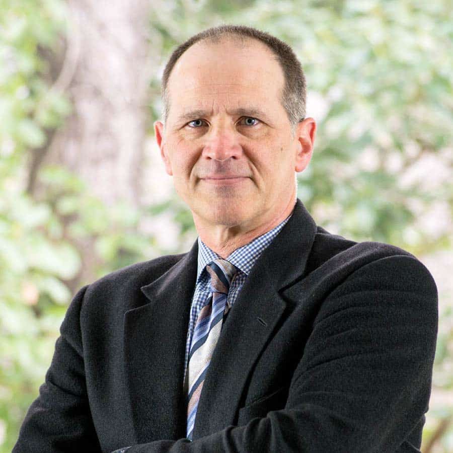 Dr. David Velling, MD posing for a headshot in a suit and tie